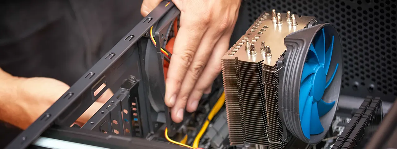 Technician reconnecting components on a computer for a computer repair service in Venice, Florida.