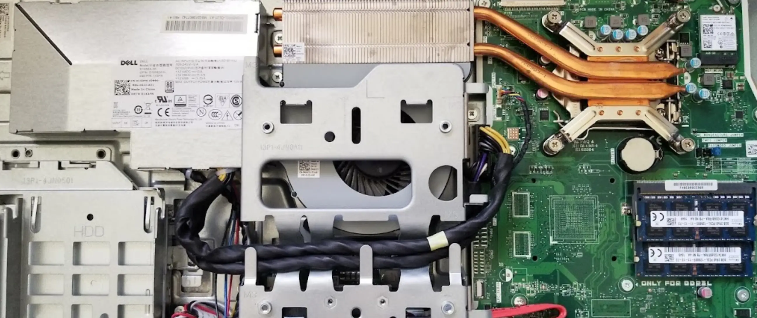 Computer technician reconnects cables to the mainboard for a computer repair in Venice, Florida.