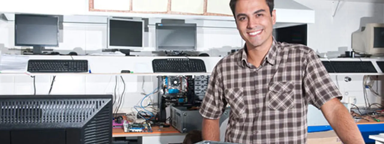 Computer technician standing in a corporate server room.