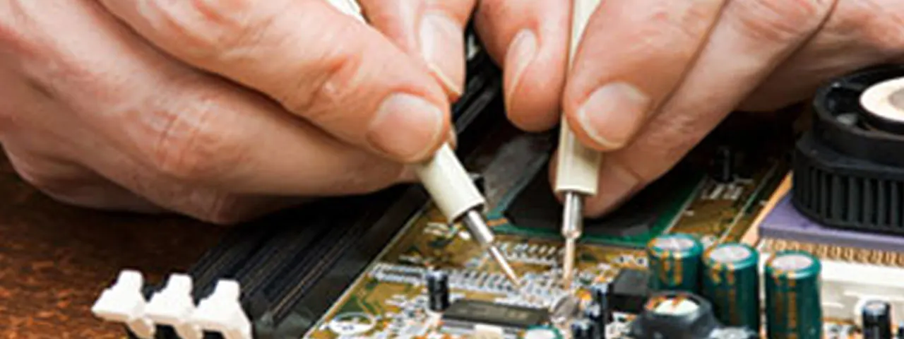 Close up of computer technician hands repairing a home or office computer board.