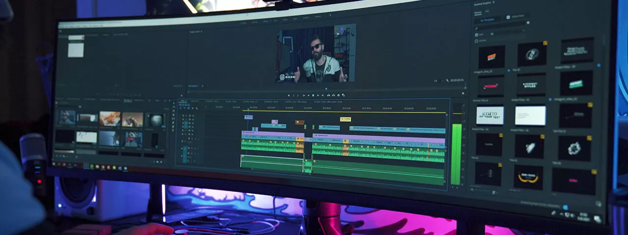Video editing in process on computer with multiple screens.